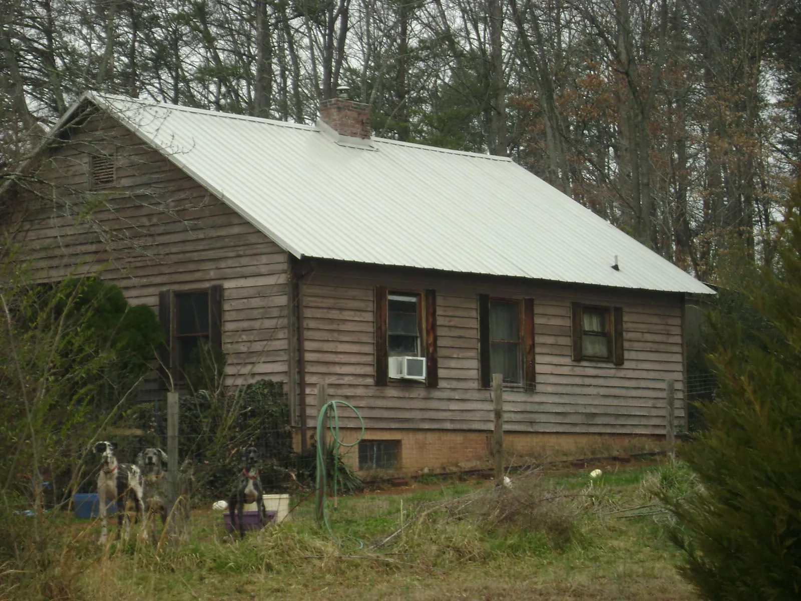 White metal roof on an old wood sided farmhouse, from a Metal Roof Installation job in Stoughton